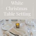 Winter white Christmas Table Setting showing plate with napkin, mercury glass ornament, silverware and crystal.