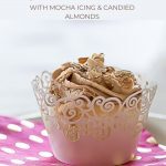 Recipes for Angel Food Cupcakes with Mocha Icing and Candied Almonds on a pink napkin with gold dots.