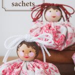 Two Lavender Sachets with fabric base and painted face.