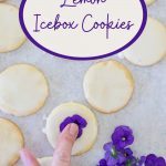 Pressing pansies into the icing on Lemon Icebox Cookies,