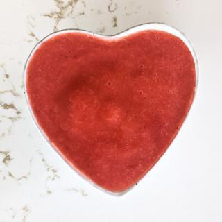 Strawberry puree in a heart shaped bowl.