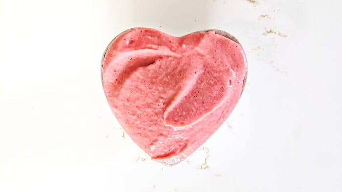 Strawberry curd in a heart-shaped bowl.