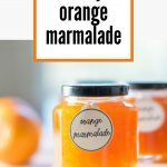 Jar of Orange Marmalade on a wooden board, in the sun.