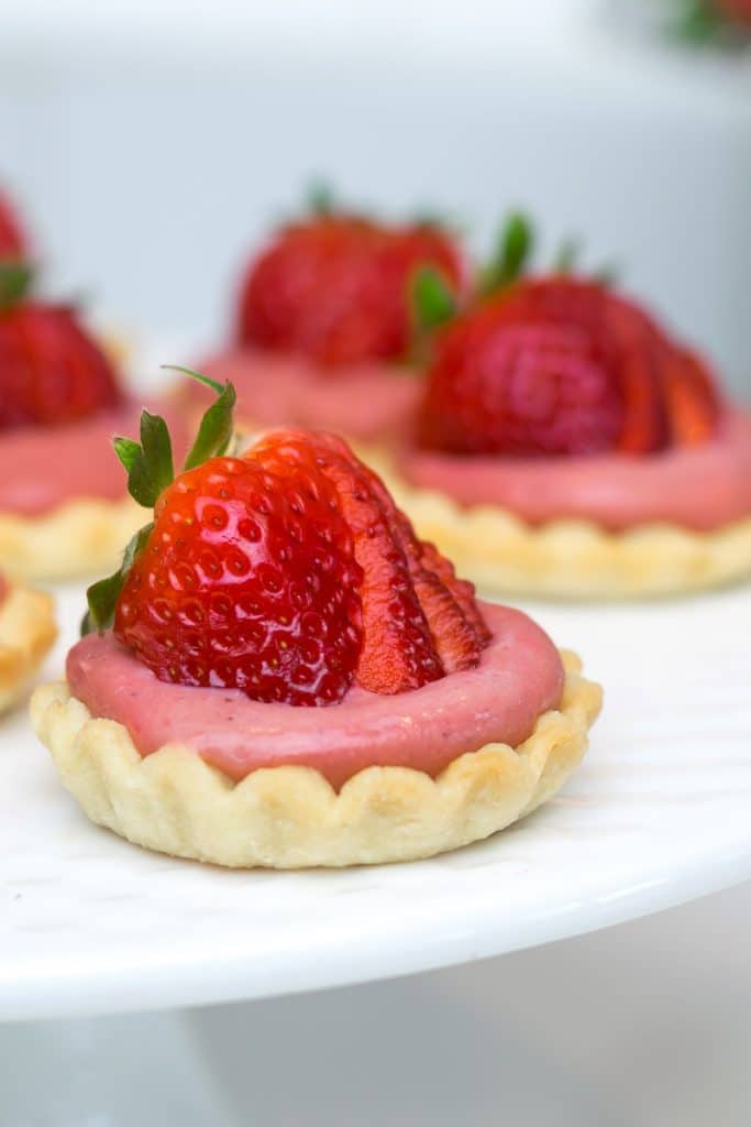 Mini Strawberry Tarts on a cake stand.