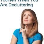 A woman looking up and considering 10 questions to ask yourself when you are decluttering.
