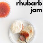 Overhead shot of strawberry rhubarb jam in a bowl and spread on a biscuit