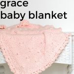 Pink Knit Baby Blanket on a white wicker table.