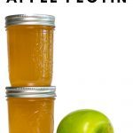 Two jars of apple pectin stock and a green apple.