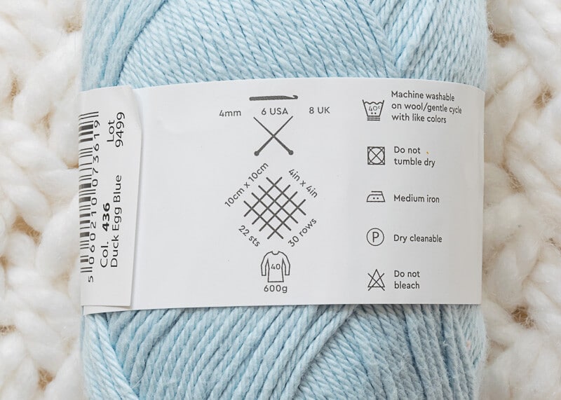 Yarn skein label showing recommended needle size and gauge.