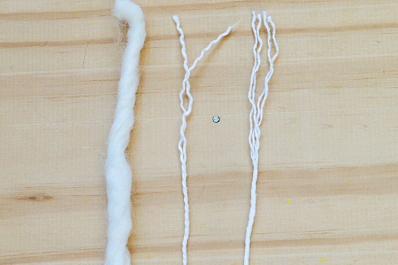 Three different strands of yarn showing different yarn plies.