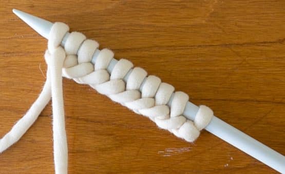 Yarn cast on a knitting needle.
