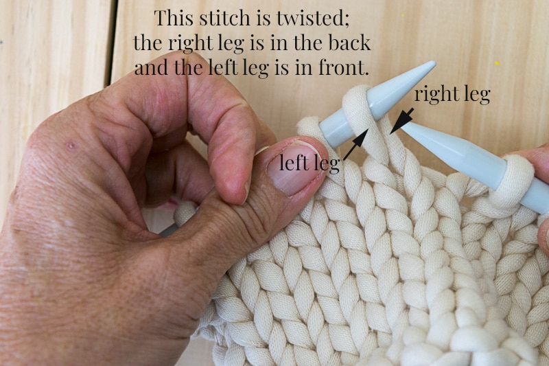 Knit fabric on needles showing how knit stitches become twisted.
