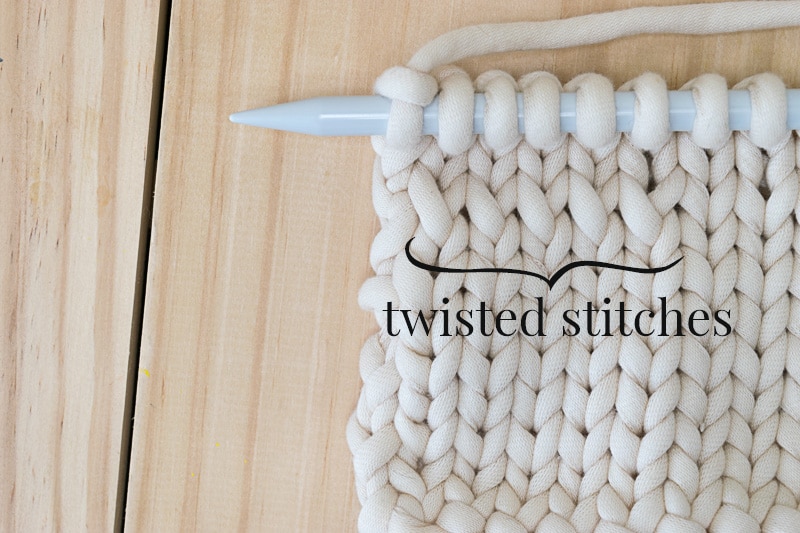 A swatch of fabric showing twisted knit stitches.