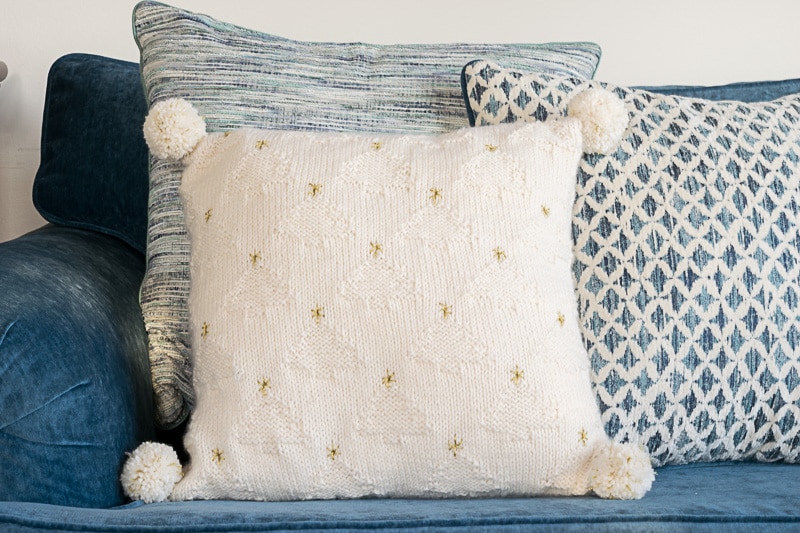 White knit pillow against blue and white pillow.