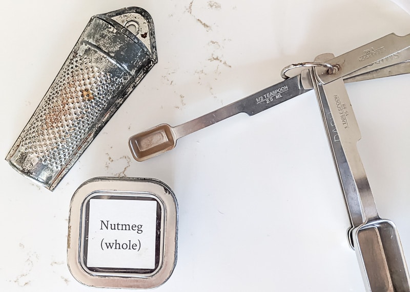 Nutmeg, grater and measuring spoons.