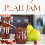 jars of pear jam with fresh pears and fresh cranberries.