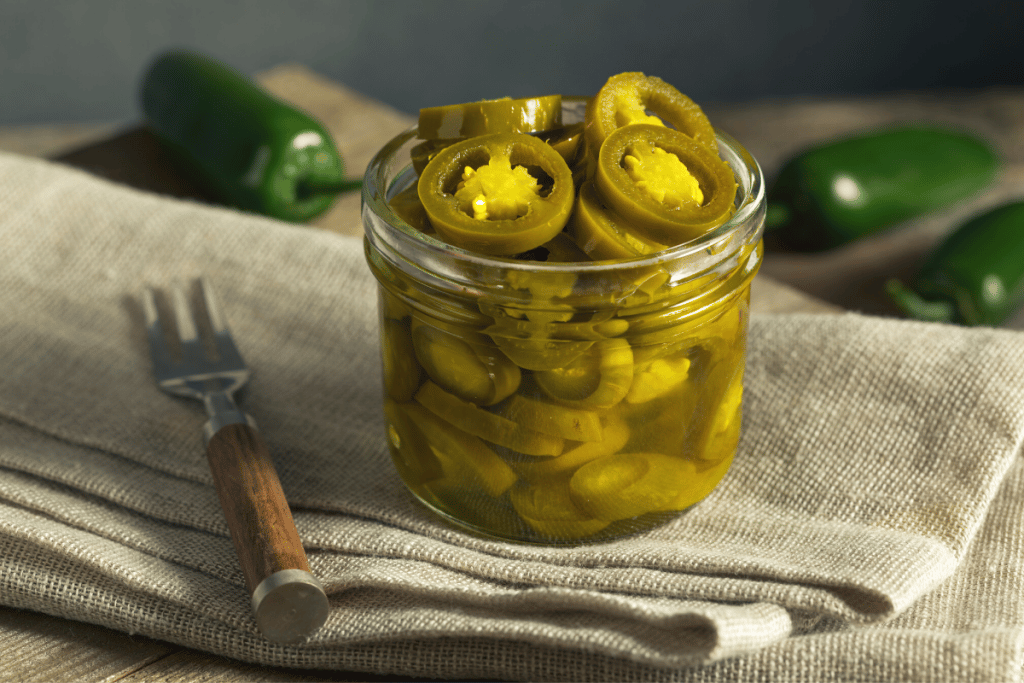 A jar of pickled jalapeño peppers.