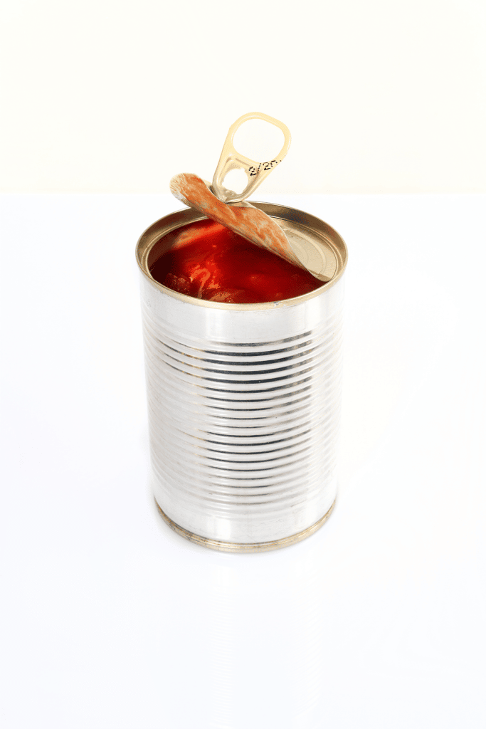 Opened aluminum can of tomato sauce.
