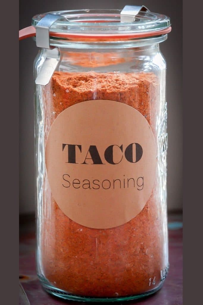 A jar of taco seasoning with a label that says \'taco seasoning.\'
