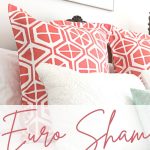 Coral and White Pillow Shams on Bed.