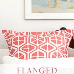 Coral and White Pillow Sham on Bed.