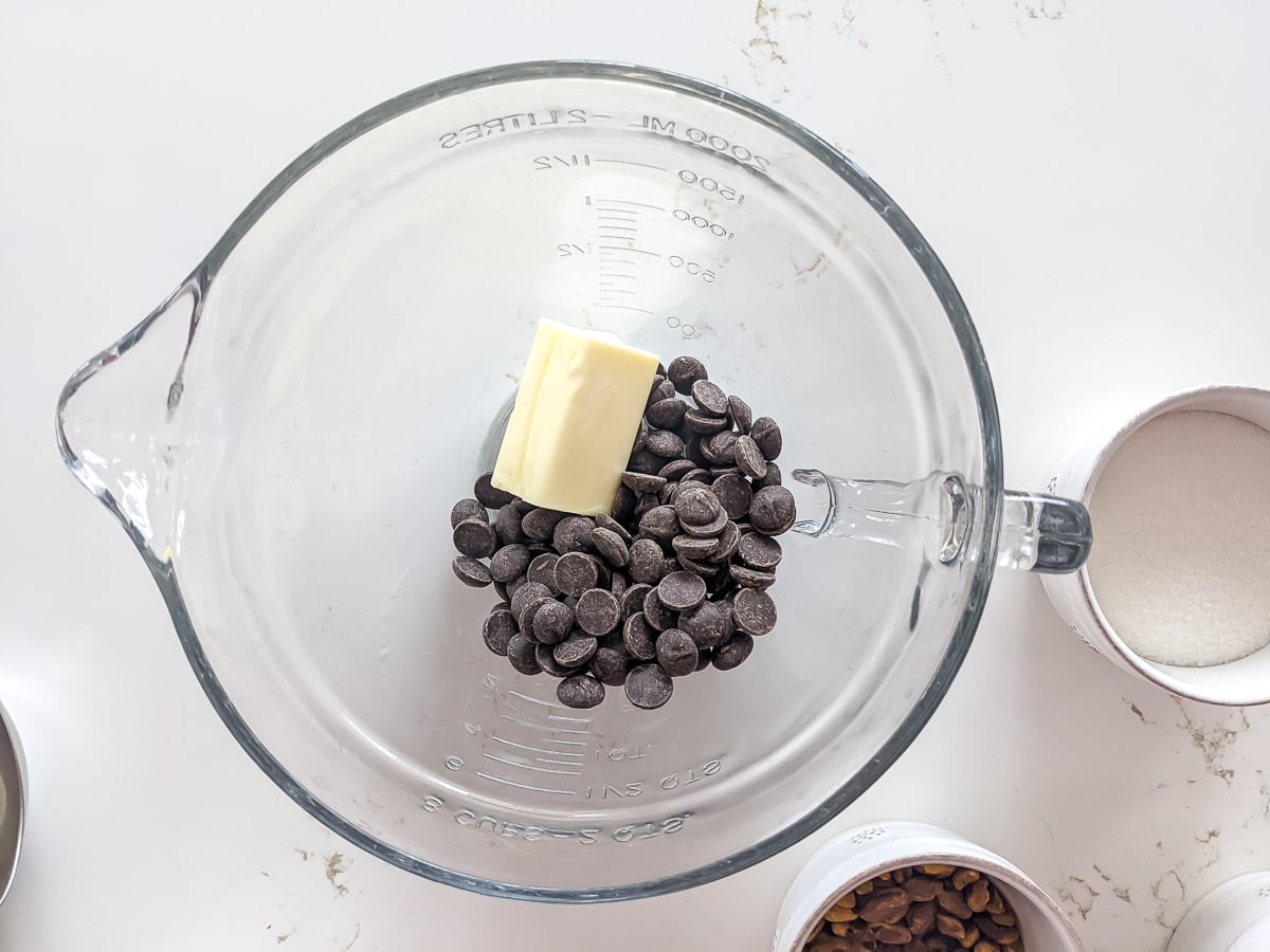 chocolate chips and butter in a clear bowl.