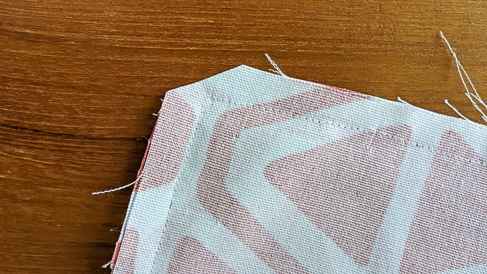 Cutting the corner on the back of fabric.