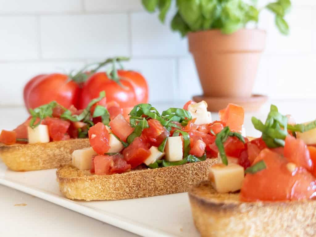 Pieces of bread with diced tomatoes and mozzarella.