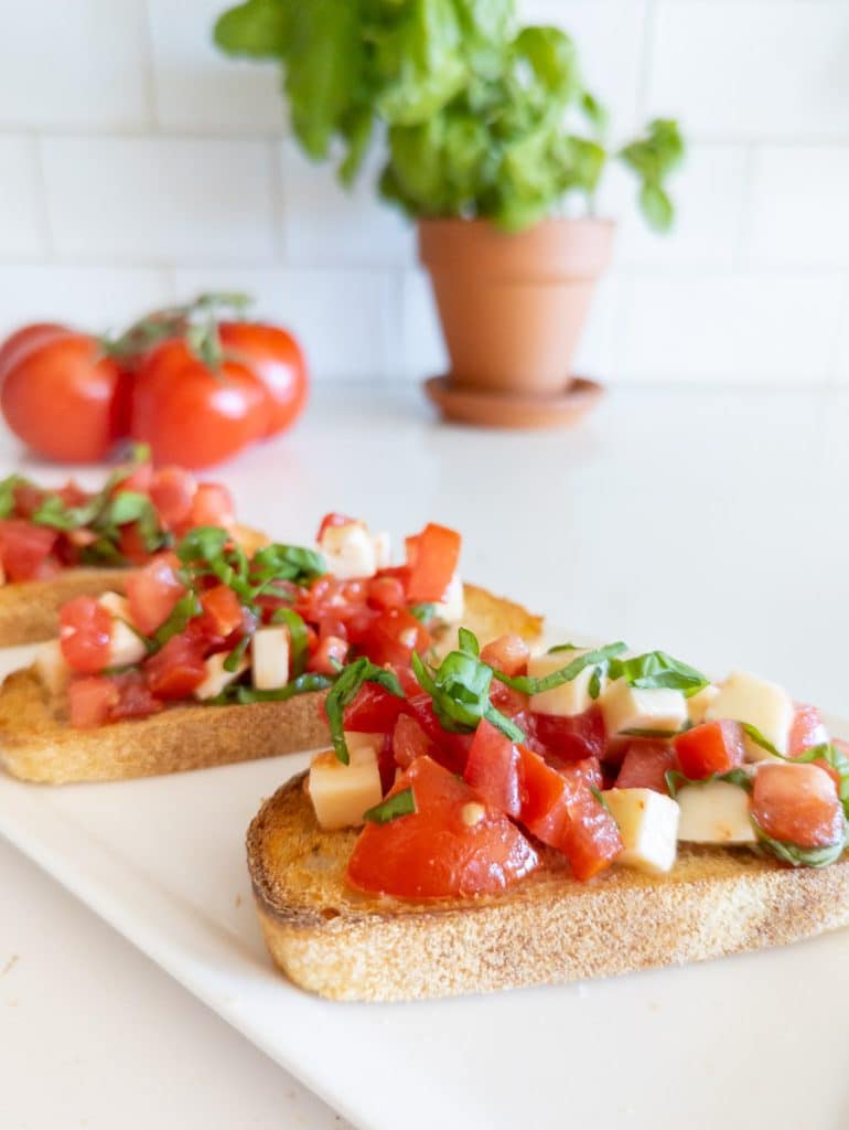 Pieces of bread with tomato, basil and mozzarella.