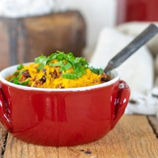 A bowl of Turkey chili sitting on top of a wooden table