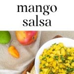 Bowl of Mango Habanero Salsa with a lime, mango and habanero pepper.