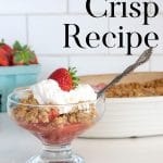 Strawberry Crisp in a bowl with a topping of whipped cream.