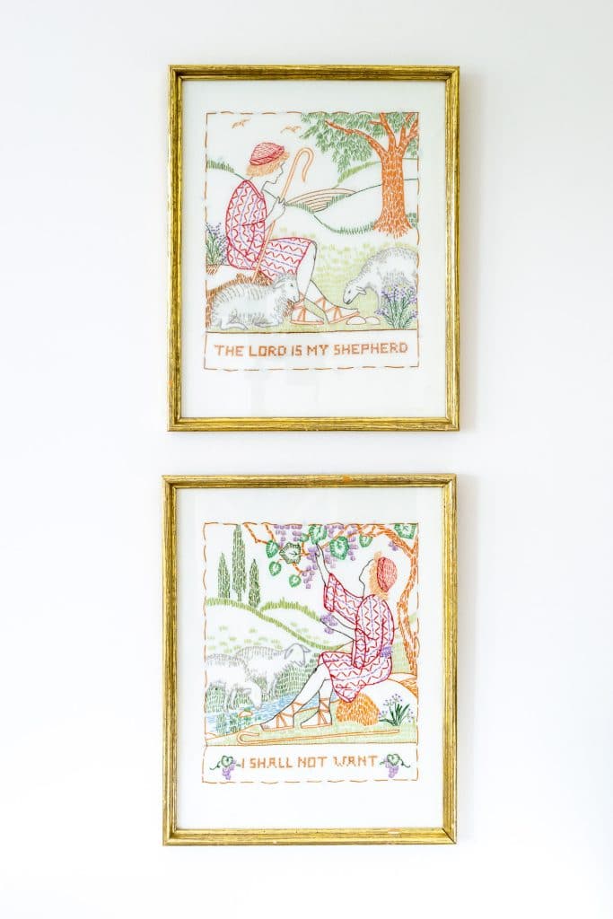 Two framed samplers on a wall.