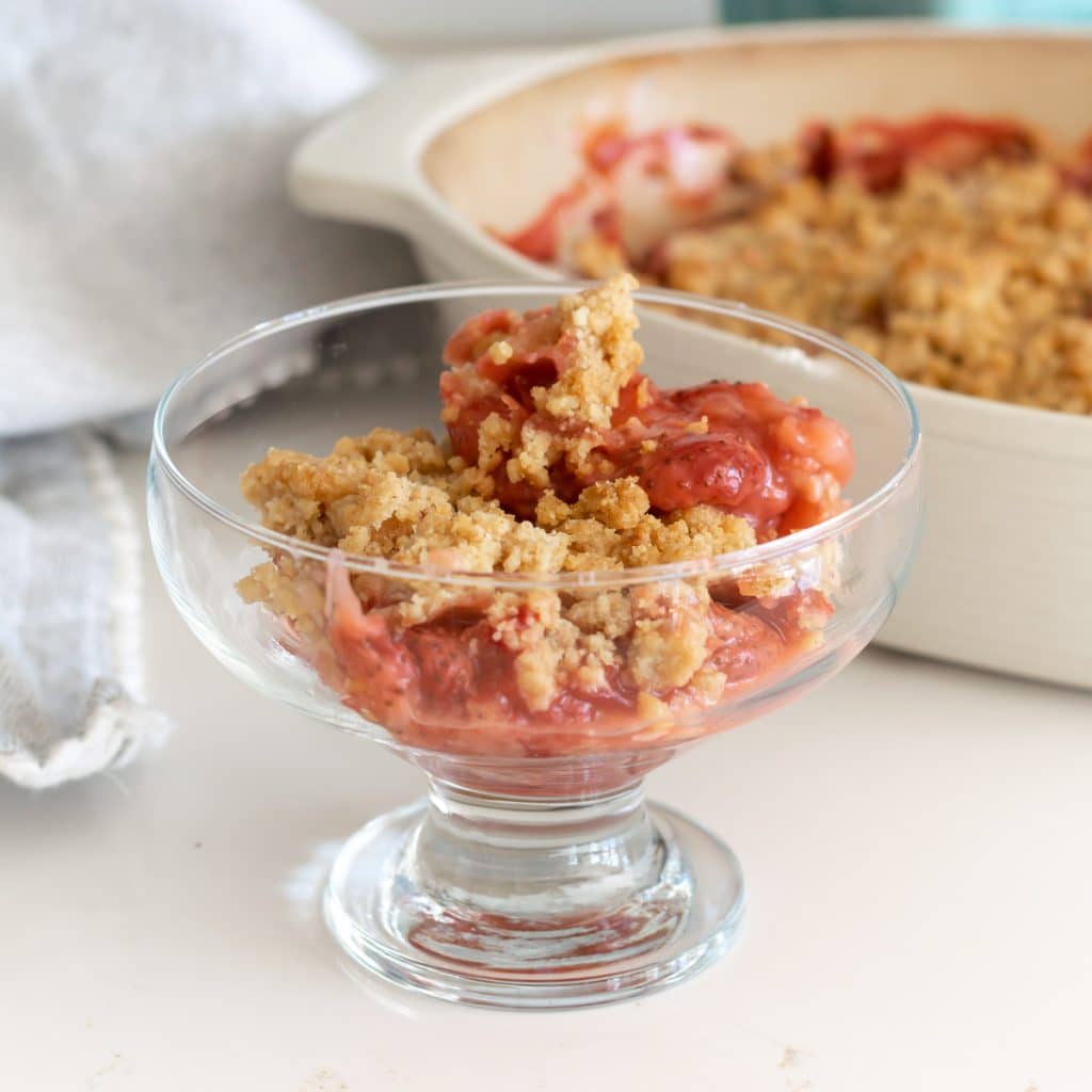 strawberry crumble in a glass bowl.