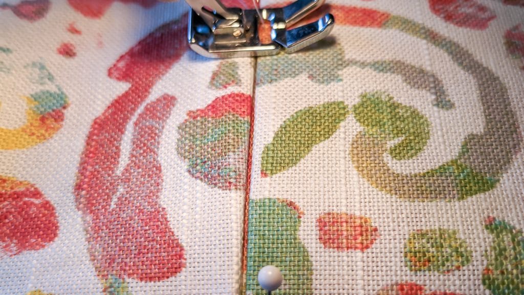 Sewing machine foot on fabric.
