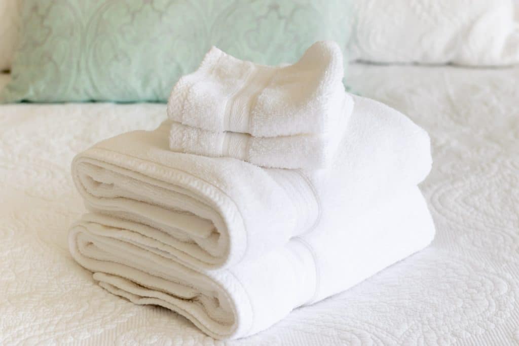 A stack of towels on a bed