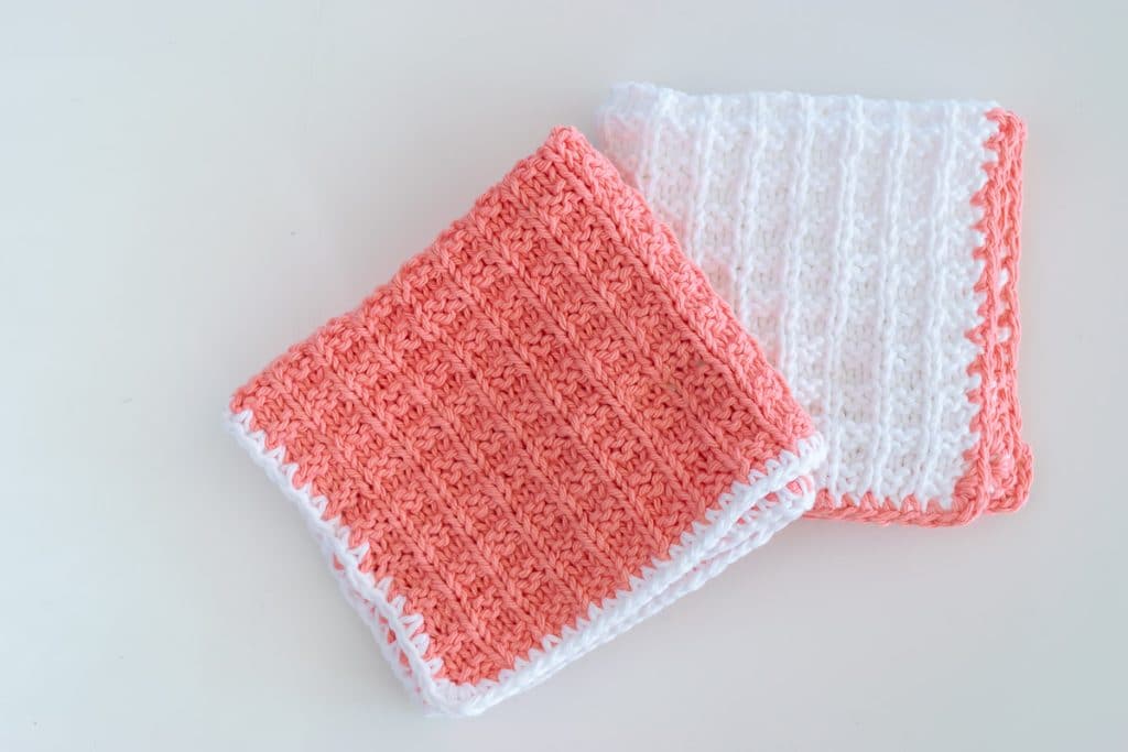 peach and white knit washcloths.