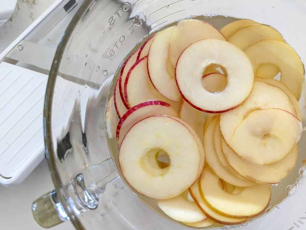 Slice apples in a glass bowl.