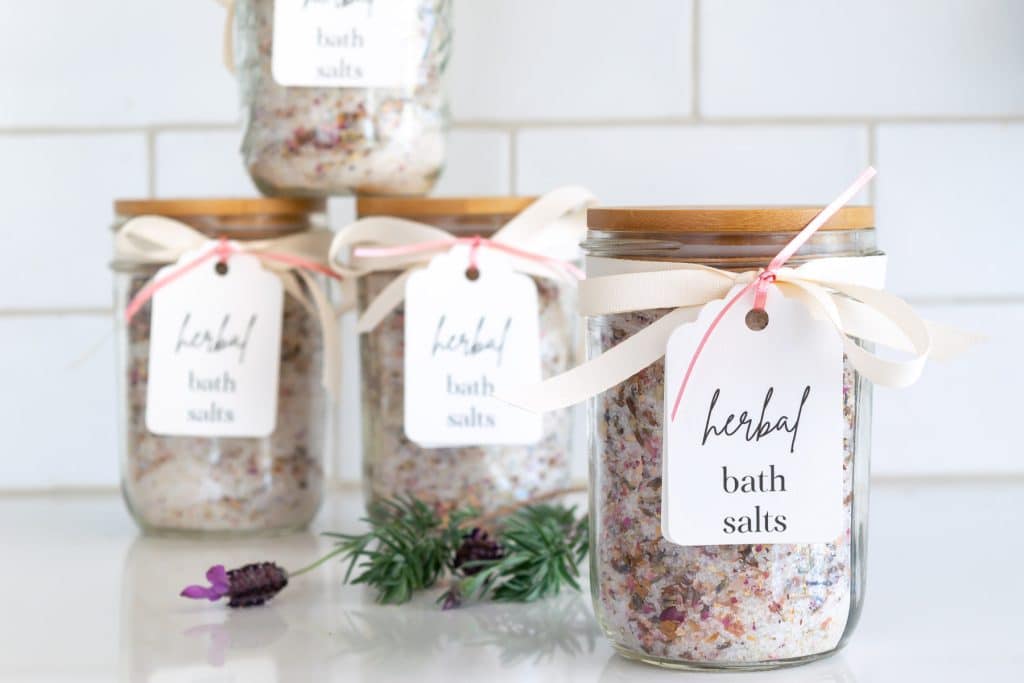 A close up of herbal bath salts in jars 