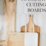 Propping cutting boards against a backsplash is one way to display a cutting board in the kitchen.