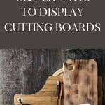 Propping cutting boards against a backsplash is one way to display a cutting board in the kitchen.
