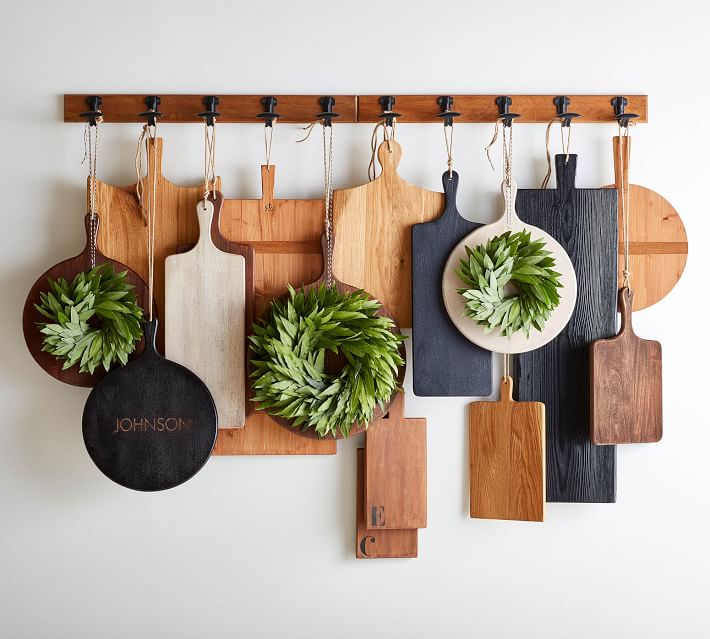 Display cutting boards hanging from a rack.