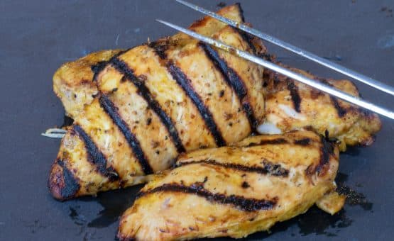 Grilled Chicken Marinade Image of 2 pieces on a slate
