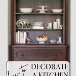 Brown wooden kitchen hutch with white dishes and serveware.