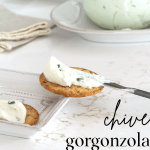 A smear of Chive Gorgonzola Cheese Spread on a cracker.