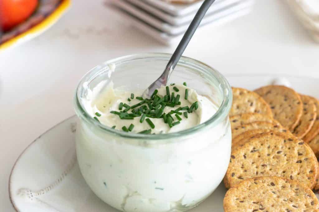 Chive Gorgonzola Cheese Spread in a jar with crackers.