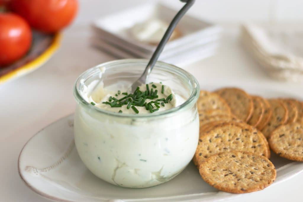 Chive Gorgonzola Cheese Spread in a jar with crackers.
