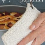 Knit Potholder holding cake pan.