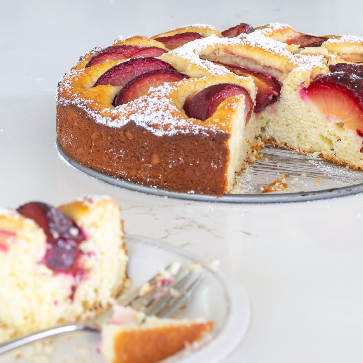 Sliced Yogurt Plum Cake, with a sliced piece in the foreground.