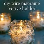 Three beaded wire macramé votive holders with lit candles inside.